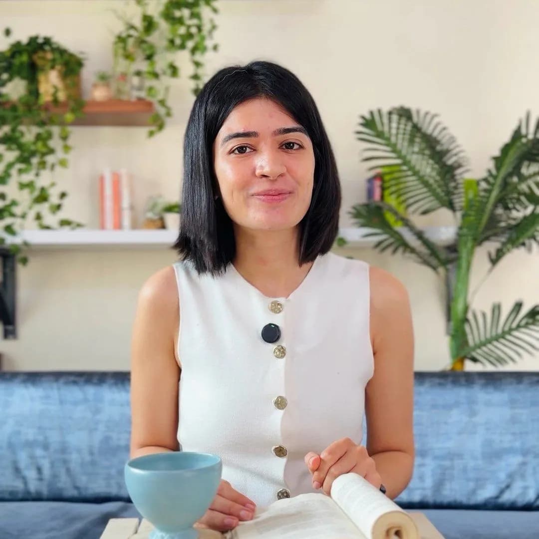 Kiran Kukreja in a white waistcoat, talking to camera outdoors: a frame from the multivitamin explainer.