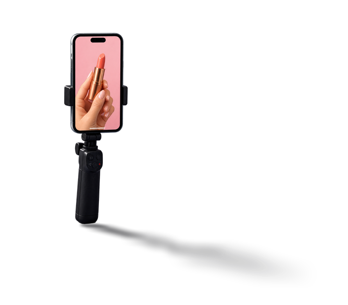 Phone held upright on a black handheld grip, screen lit
