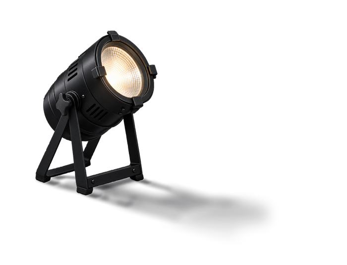Black fresnel spotlight on its floor stand, lamp lit