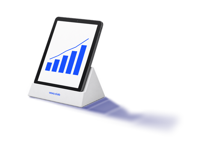 Tablet on a white wedge, an abstract rising chart on its screen